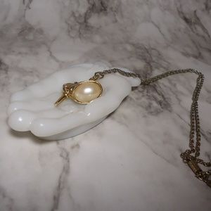 1928 Gold tone pearl like pendant with key